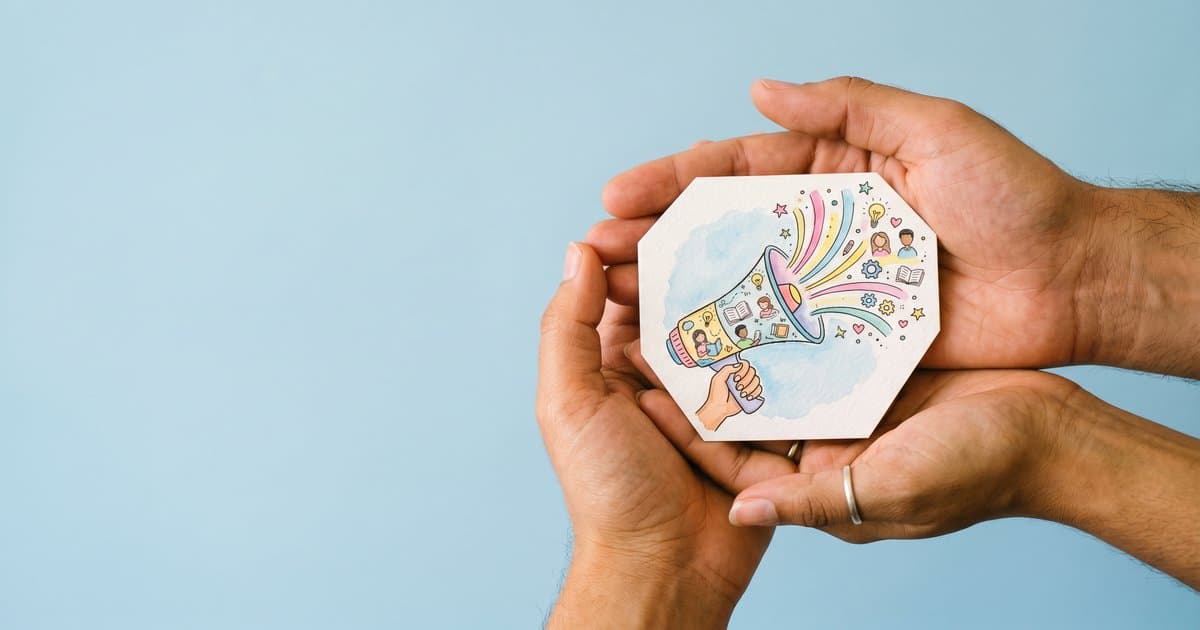 Hands holding an illustrated megaphone representing student voice in schools