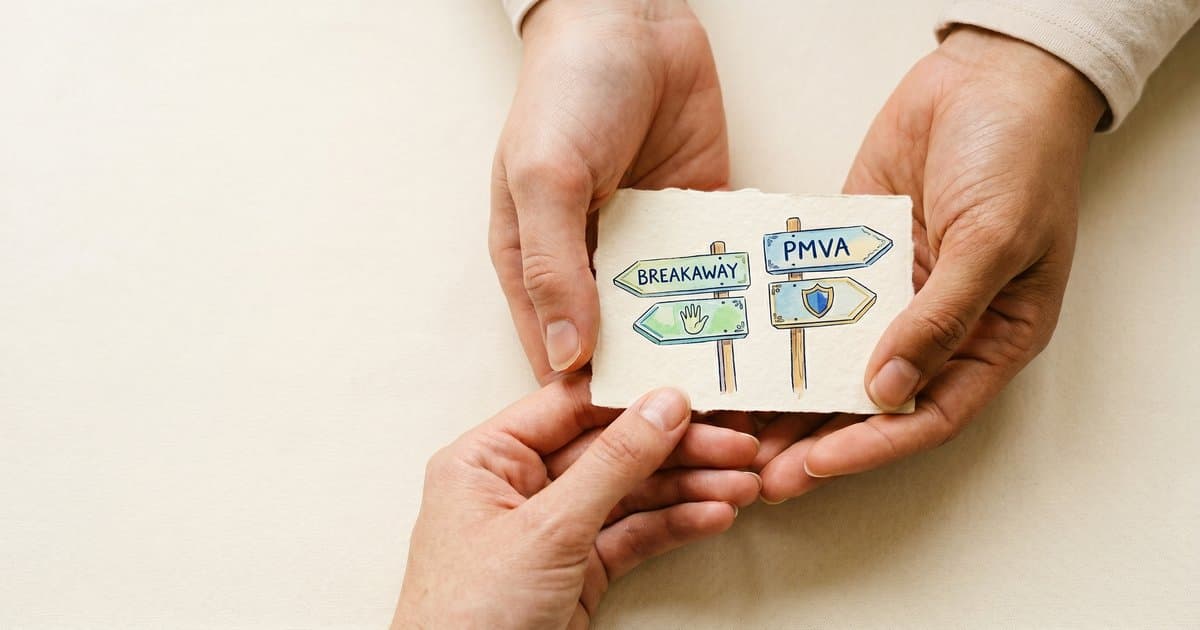 Hands holding two illustrated signposts representing PMVA training versus breakaway training