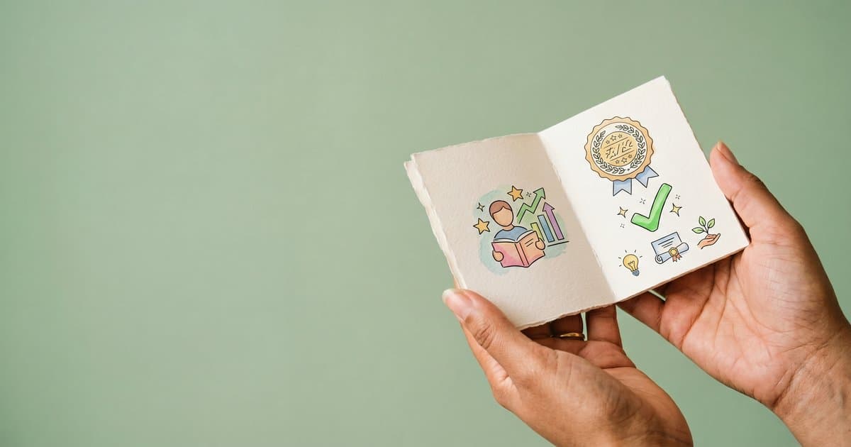 Hands holding an illustrated guidebook to BILD Act RRN training