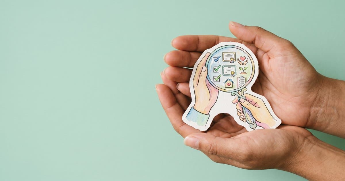 Hands holding a magnifying glass showing CQC inspection evidence
