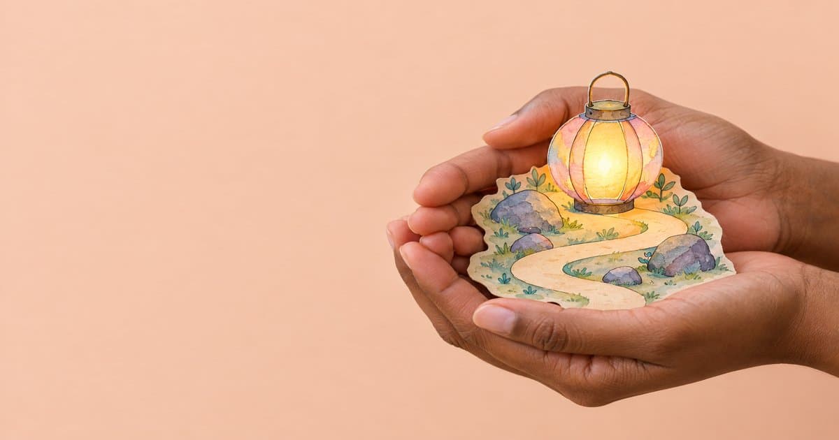 Hands holding a glowing watercolour lantern lighting a safe winding path between small stones